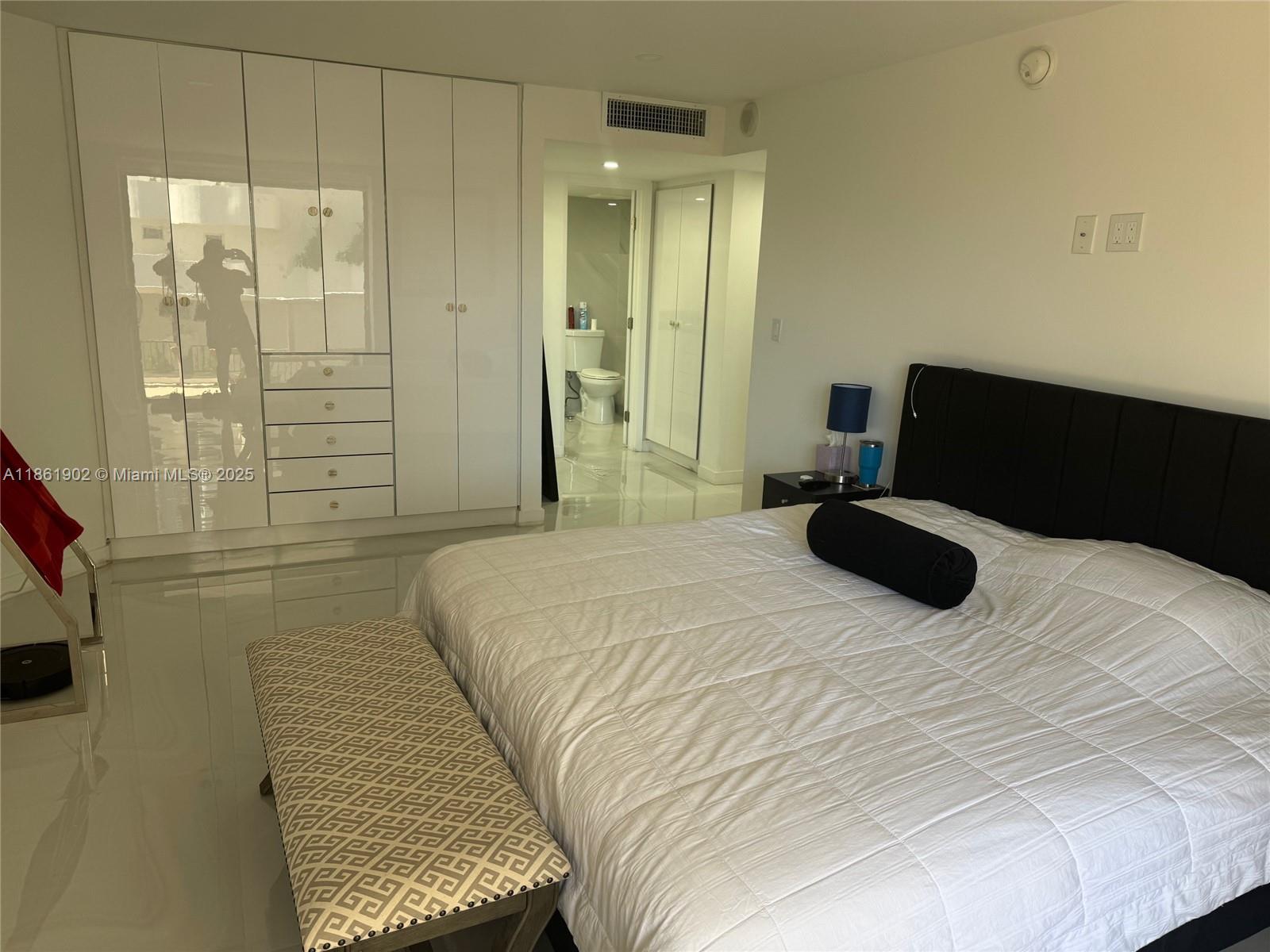 6423 Collins Avenue, Unit 401 Miami Beach, FL 33141 - Photo 15 of 17 a bedroom with a bed and a shower