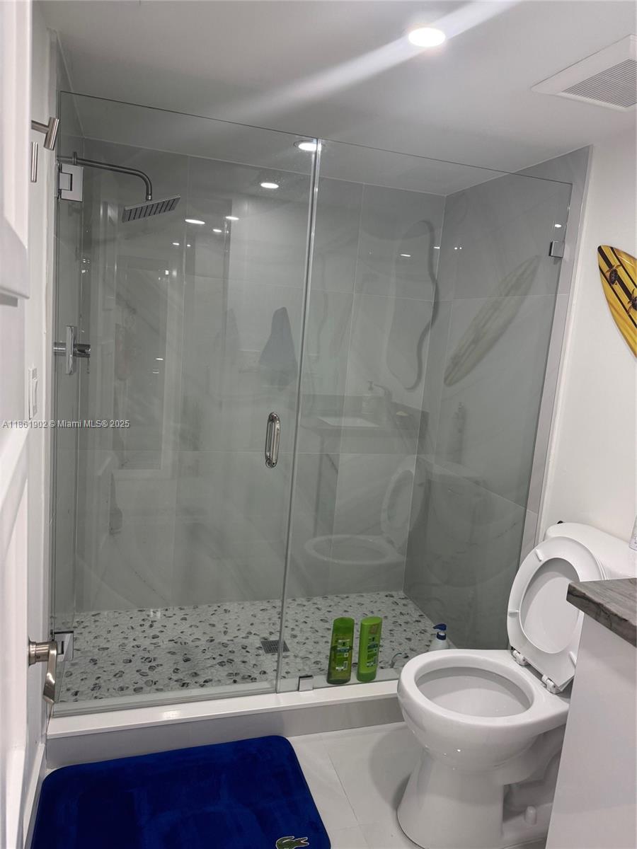 6423 Collins Avenue, Unit 401 Miami Beach, FL 33141 - Photo 4 of 17 a bathroom with a shower and a toilet