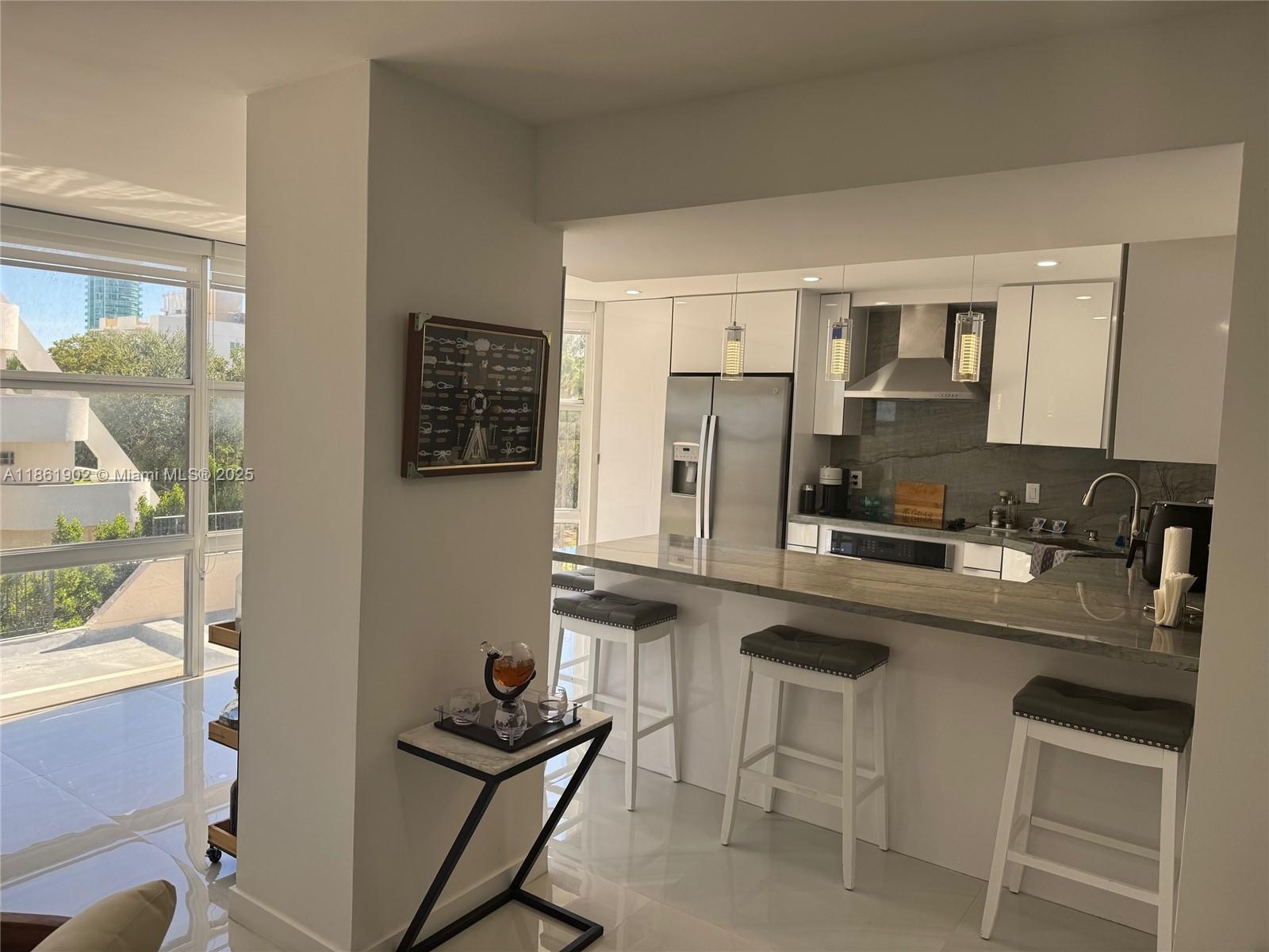 6423 Collins Avenue, Unit 401 Miami Beach, FL 33141 - Photo 5 of 17 a kitchen with stainless steel appliances a sink stove and refrigerator