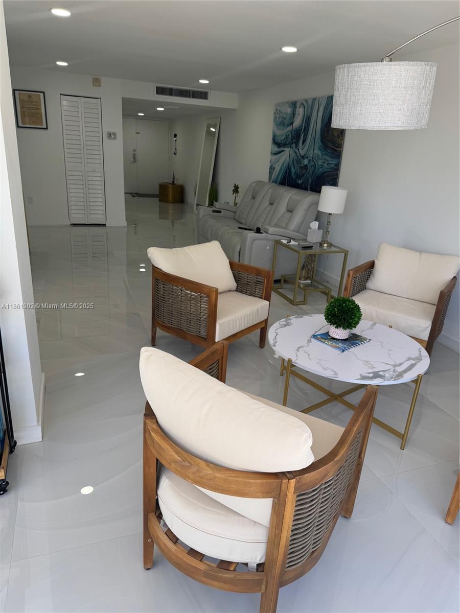 6423 Collins Avenue, Unit 401 Miami Beach, FL 33141 - Photo 10 of 17 a room with furniture and a wooden floor