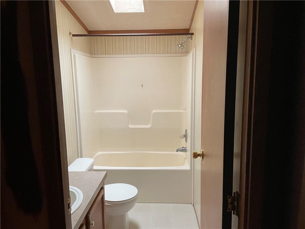 112 Vance Road New Castle, PA 16102 - Photo 4 of 5 a bathroom with a shower a toilet and a sink