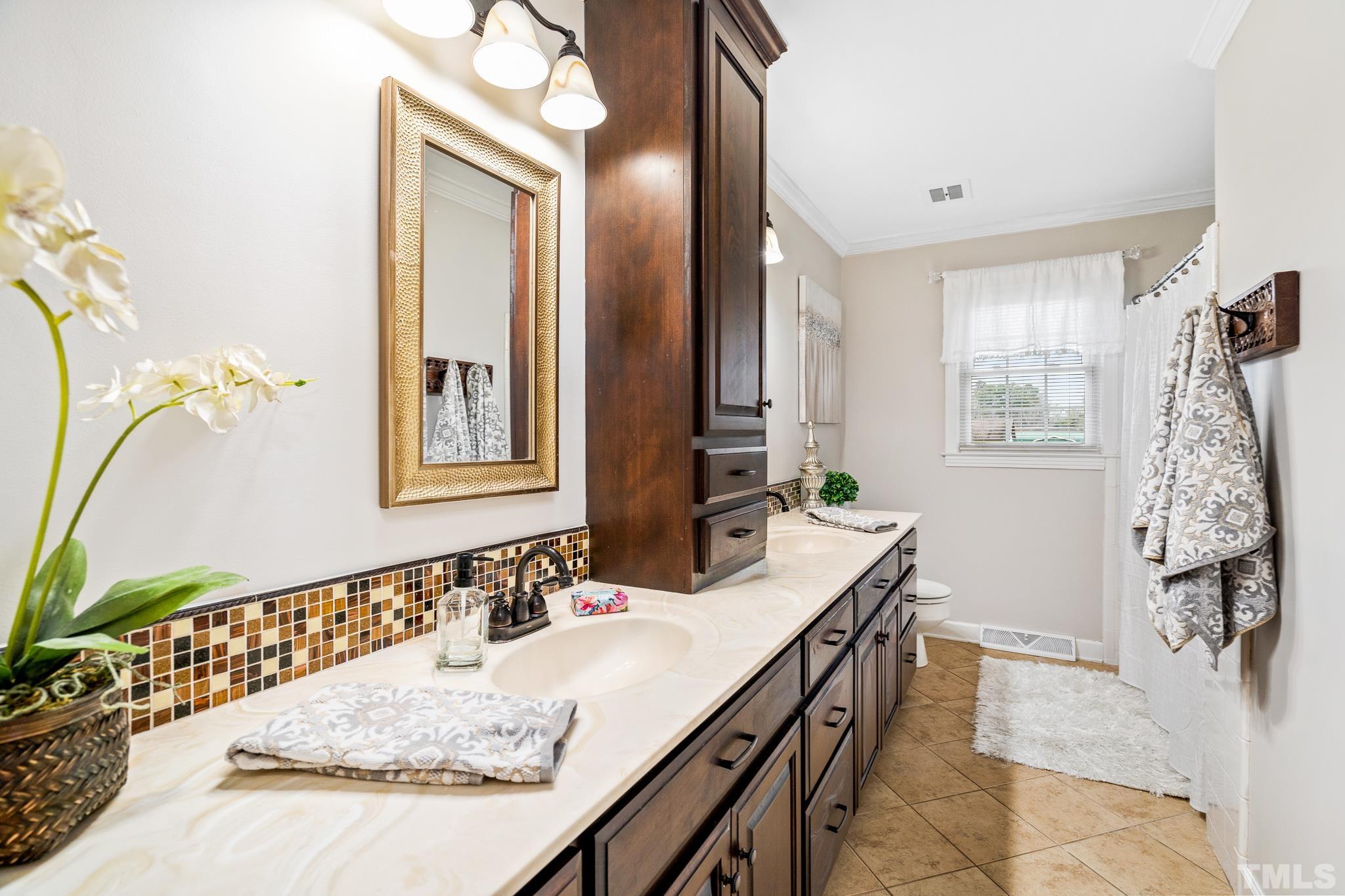 7630 High Rock Road Efland, NC 27243 - Photo 12 of 25 a bathroom with a granite countertop sink a mirror and a shower