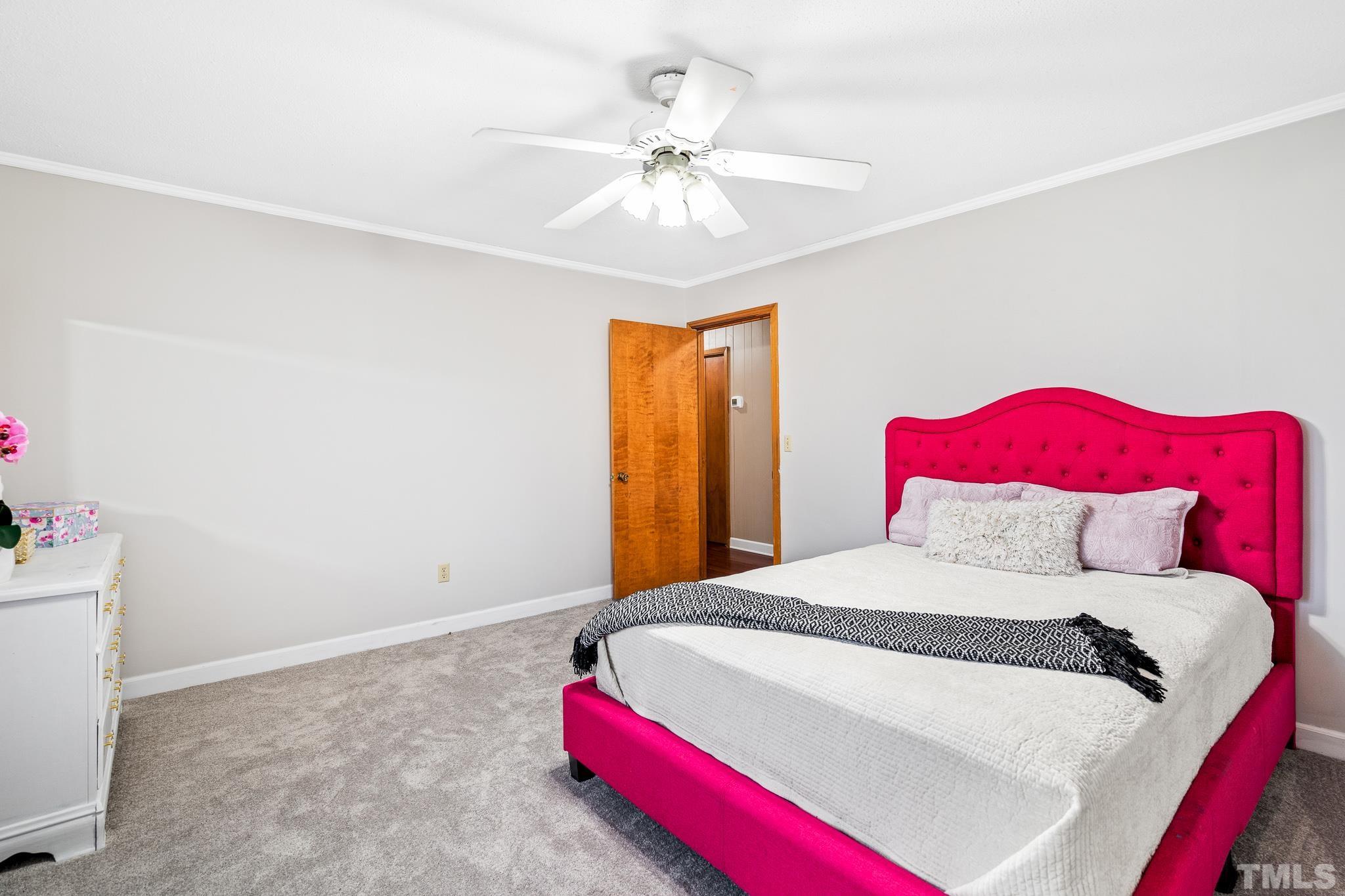 7630 High Rock Road Efland, NC 27243 - Photo 13 of 25 a bedroom with a bed and a chandelier