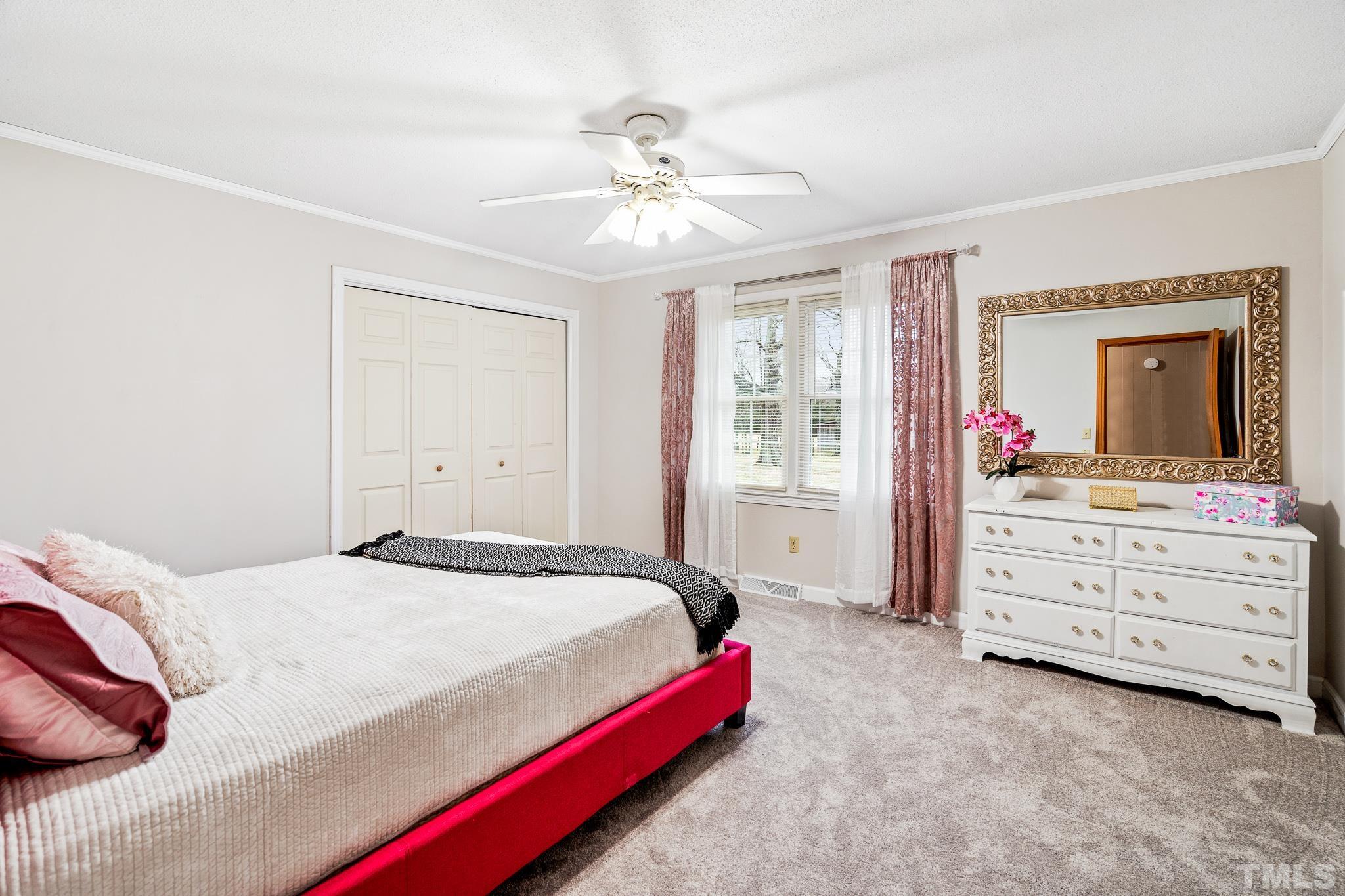 7630 High Rock Road Efland, NC 27243 - Photo 14 of 25 a bedroom with a bed and a chandelier