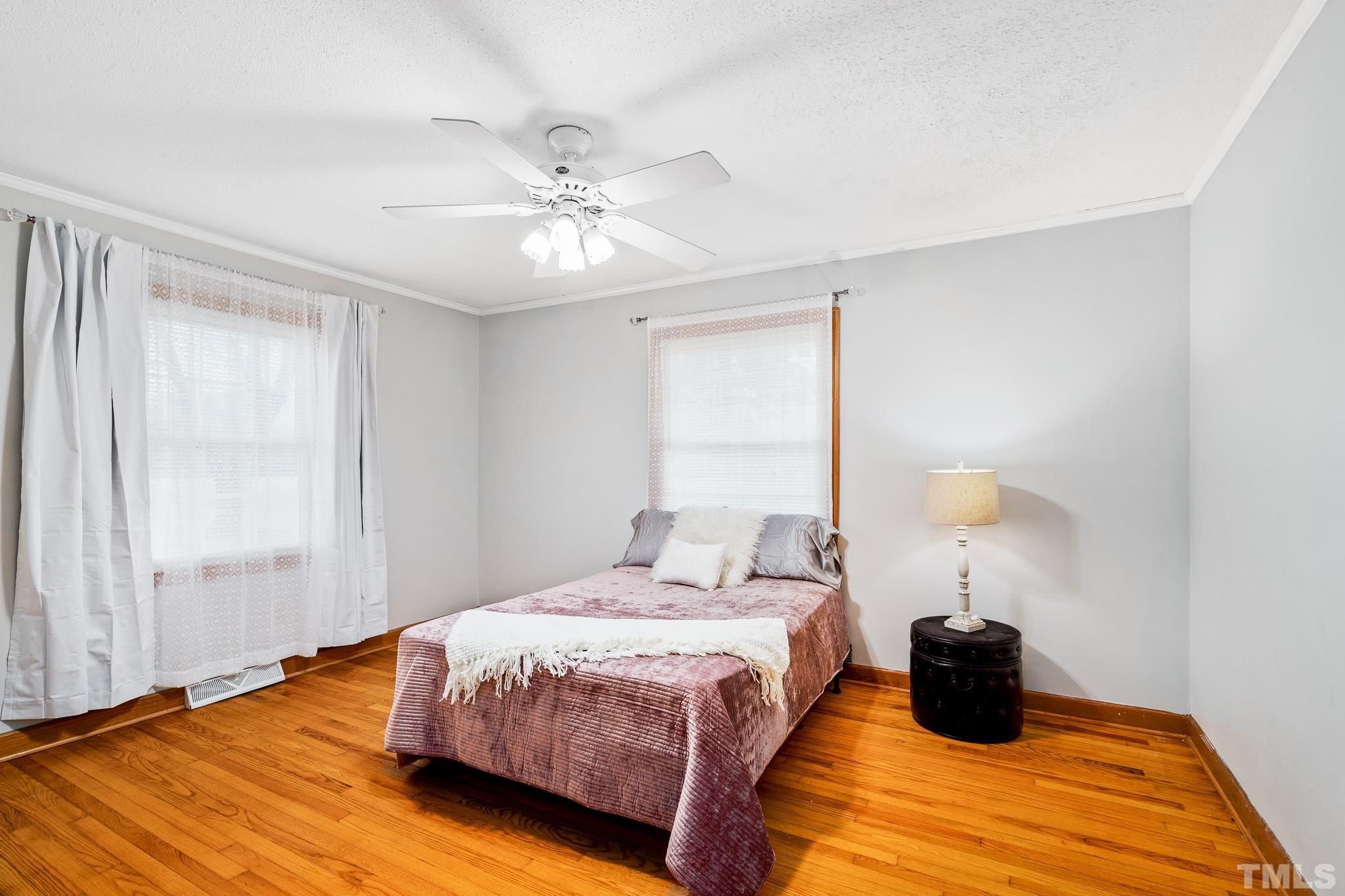 7630 High Rock Road Efland, NC 27243 - Photo 15 of 25 a bedroom with a bed lamp and a window