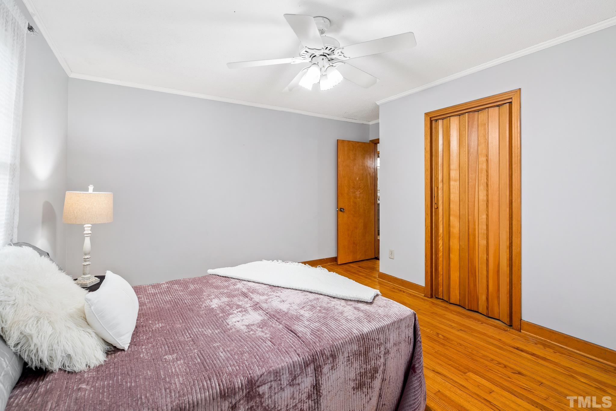 7630 High Rock Road Efland, NC 27243 - Photo 16 of 25 a bedroom with a bed and a chandelier