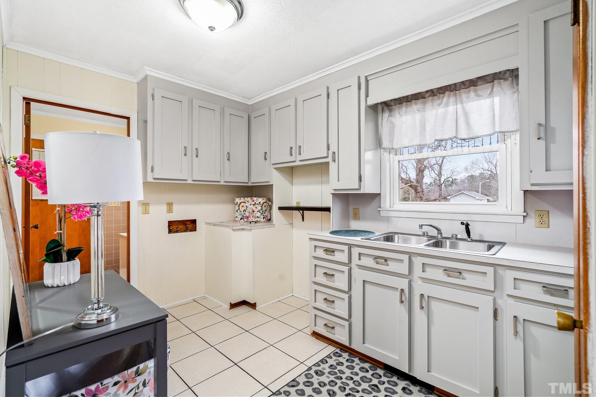 7630 High Rock Road Efland, NC 27243 - Photo 17 of 25 a kitchen with cabinets appliances and a window