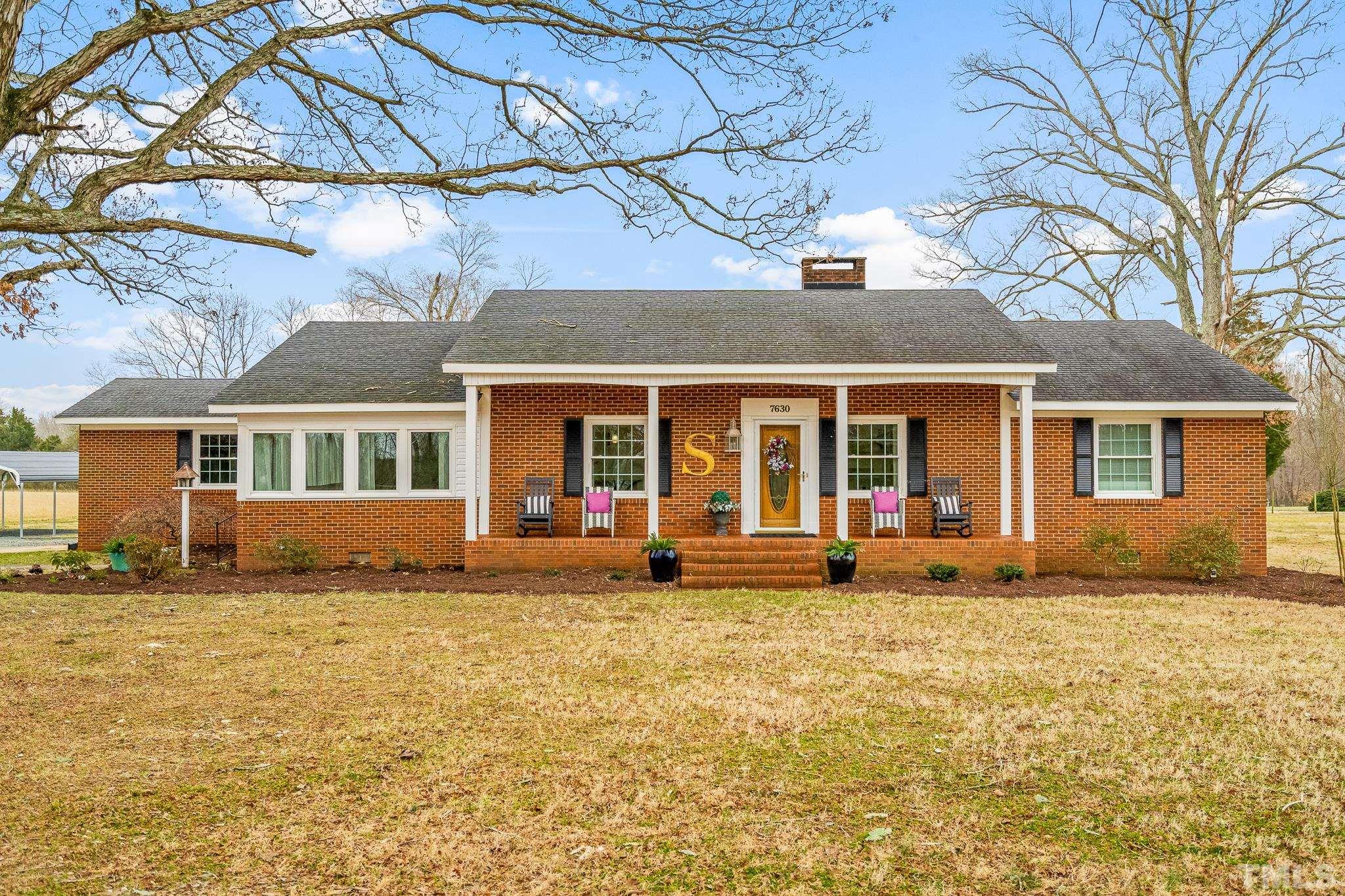 7630 High Rock Road Efland, NC 27243 - Photo 20 of 25 a front view of a house with a yard and outdoor seating