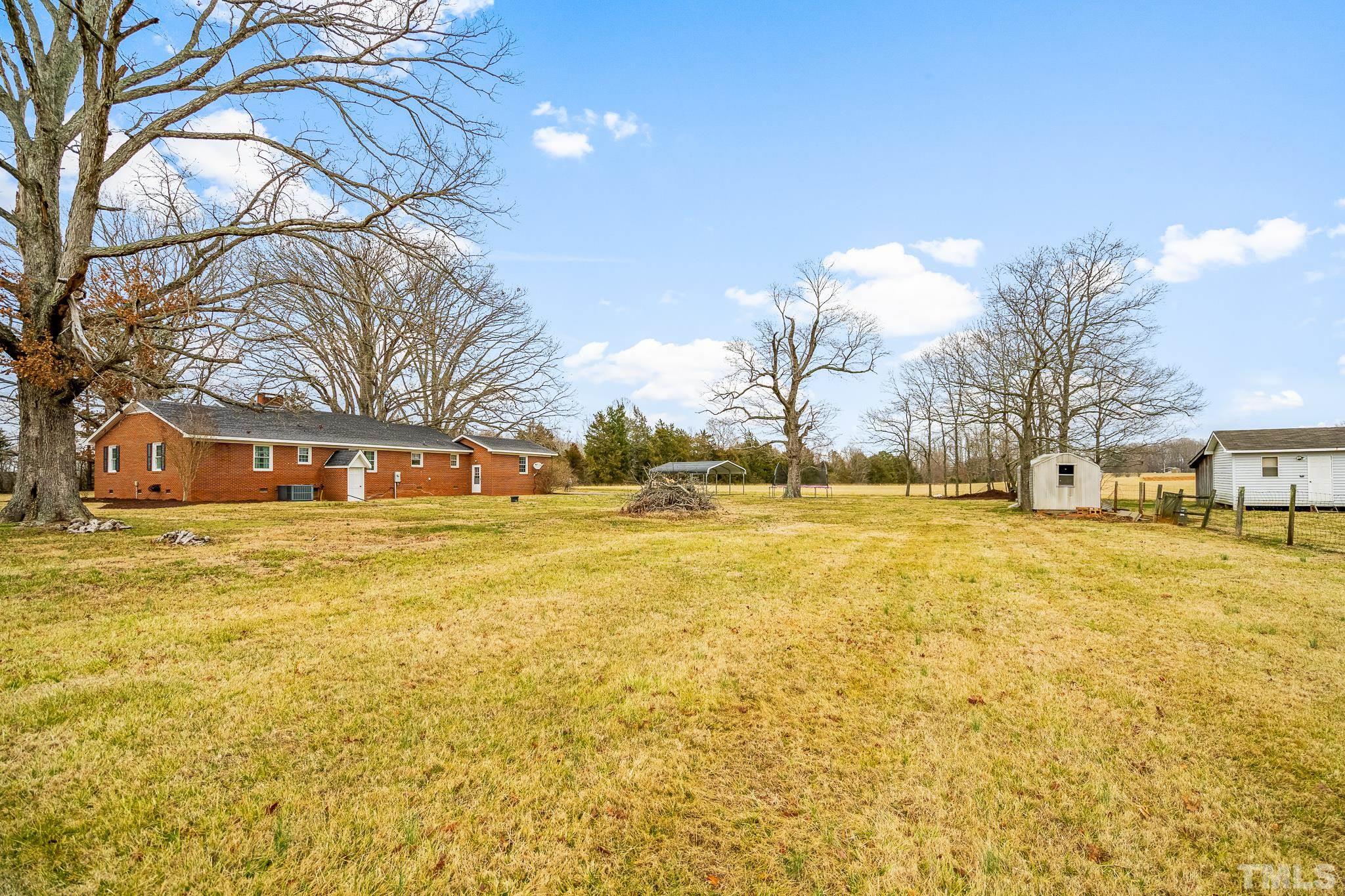 7630 High Rock Road Efland, NC 27243 - Photo 23 of 25 a front view of residential houses with yard and trees