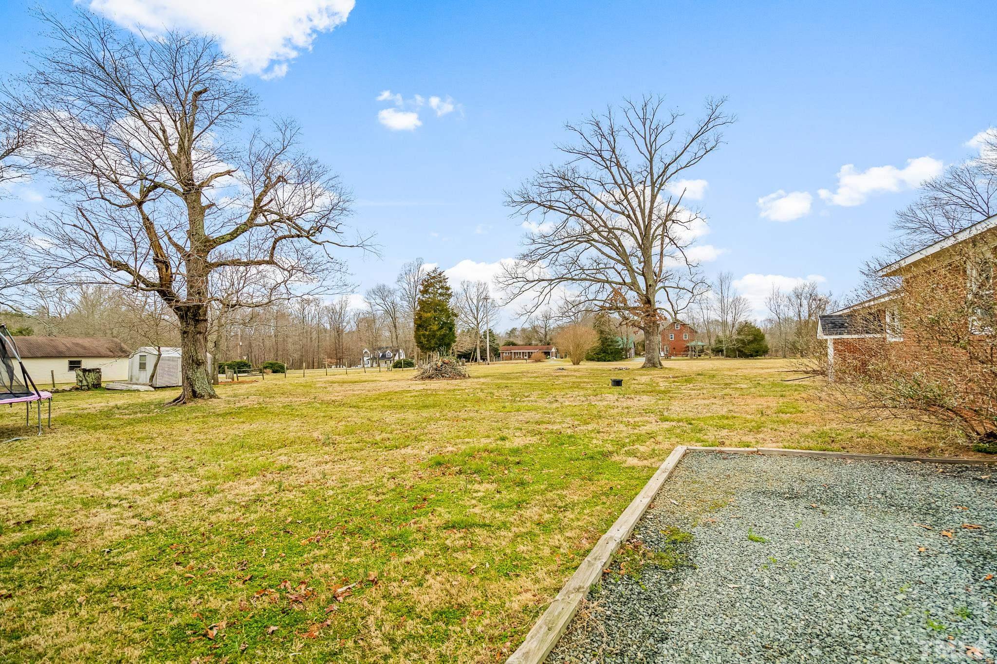 7630 High Rock Road Efland, NC 27243 - Photo 24 of 25 a swimming pool with trees in front of it