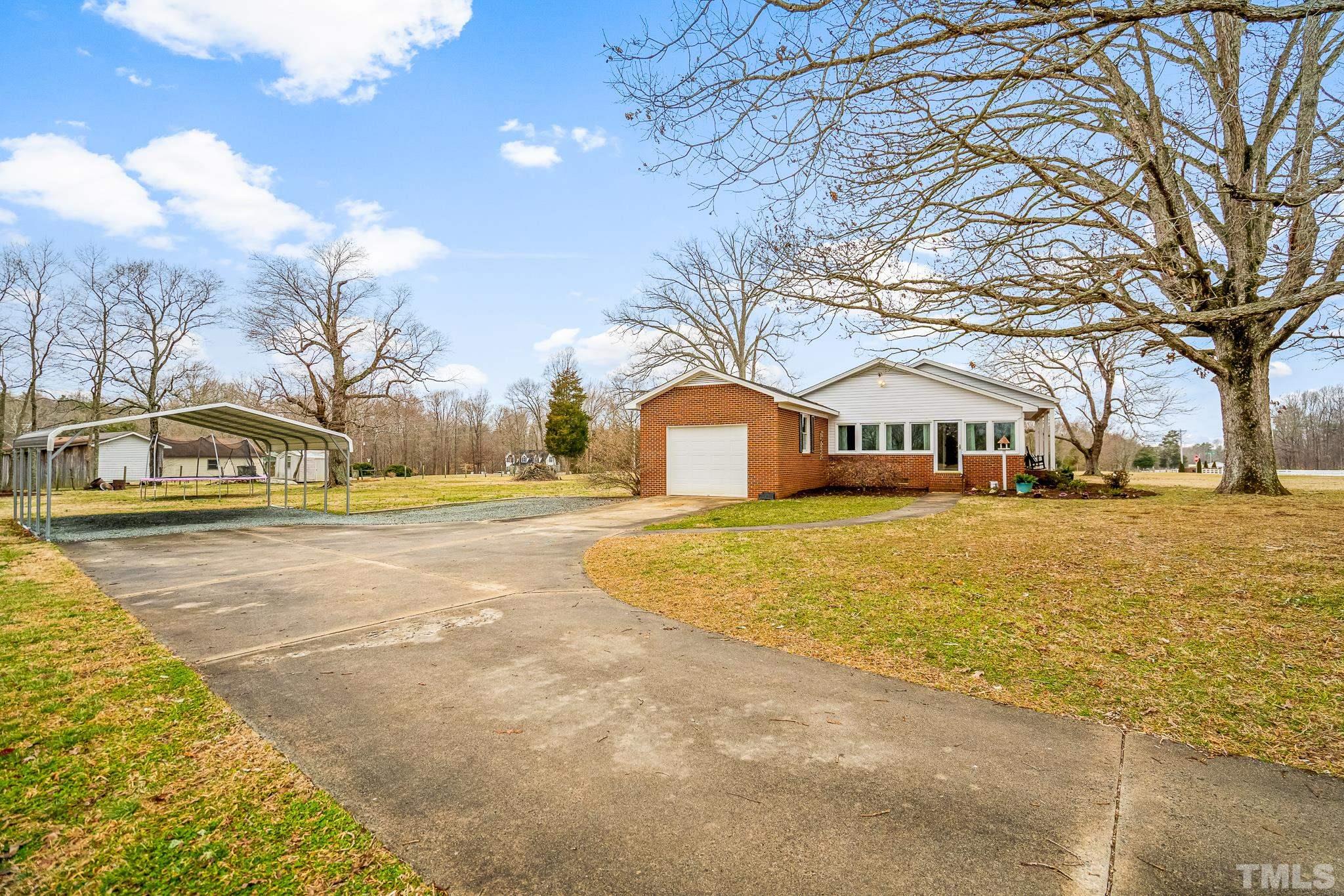 7630 High Rock Road Efland, NC 27243 - Photo 25 of 25 a front view of residential houses with yard and trees