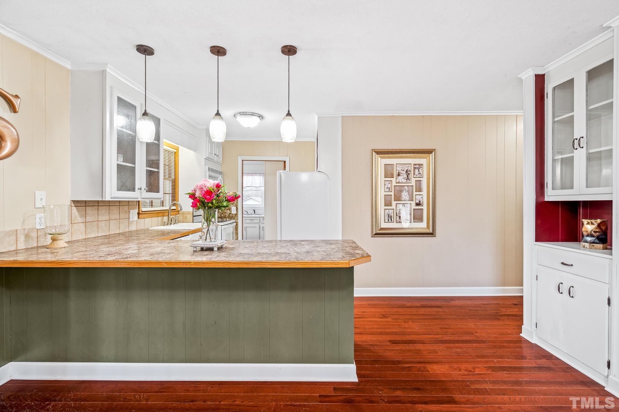 7630 High Rock Road Efland, NC 27243 - Photo 8 of 25 a kitchen with kitchen island granite countertop a sink cabinets and wooden floor