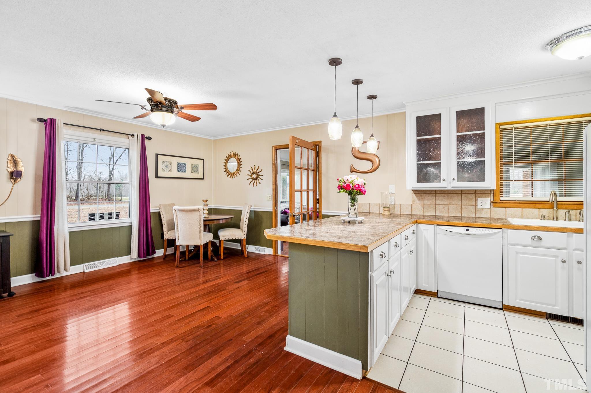 7630 High Rock Road Efland, NC 27243 - Photo 9 of 25 a living room with granite countertop furniture a dining table and chairs with wooden floor