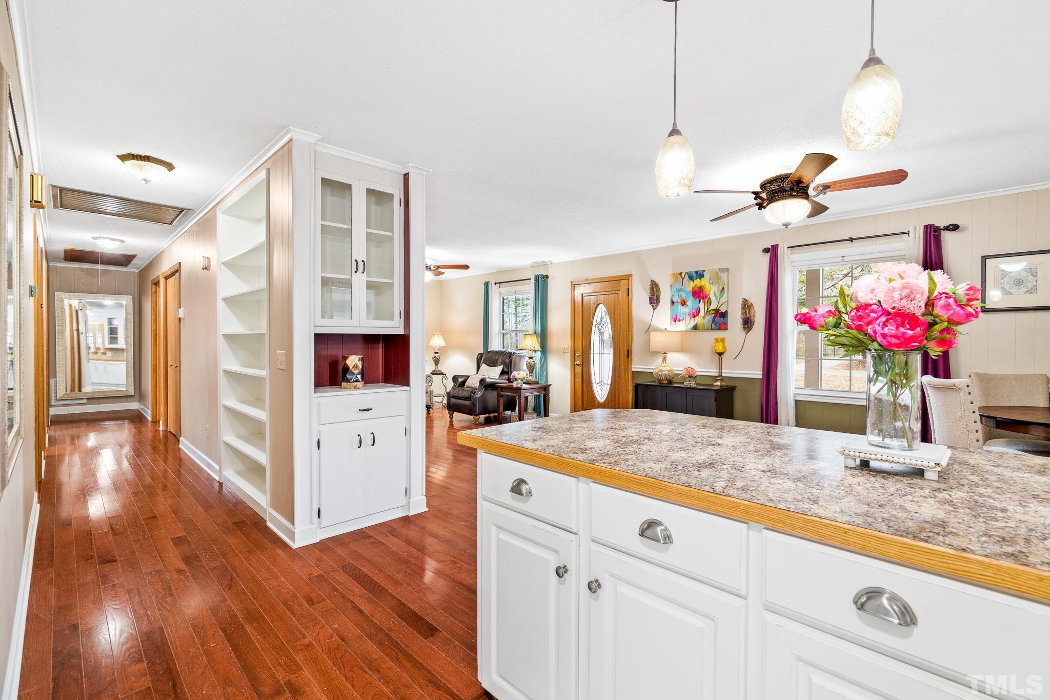 7630 High Rock Road Efland, NC 27243 - Photo 10 of 25 a open kitchen with kitchen island cabinets and wooden floor