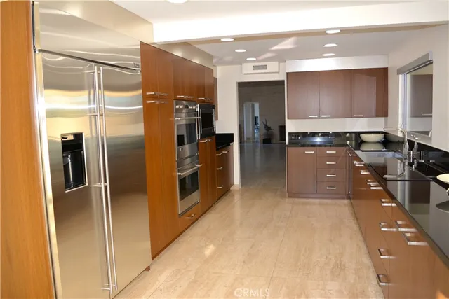 a kitchen with stainless steel appliances a refrigerator and a sink