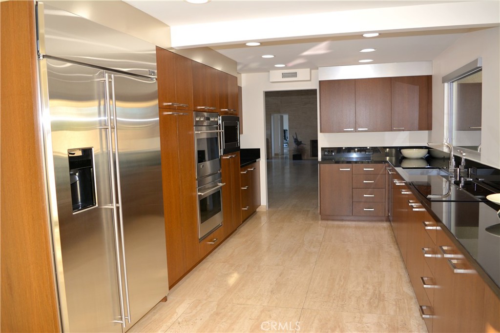 40231 Club View Drive Rancho Mirage, CA 92270 - Photo 11 of 37 a kitchen with stainless steel appliances a refrigerator and a sink