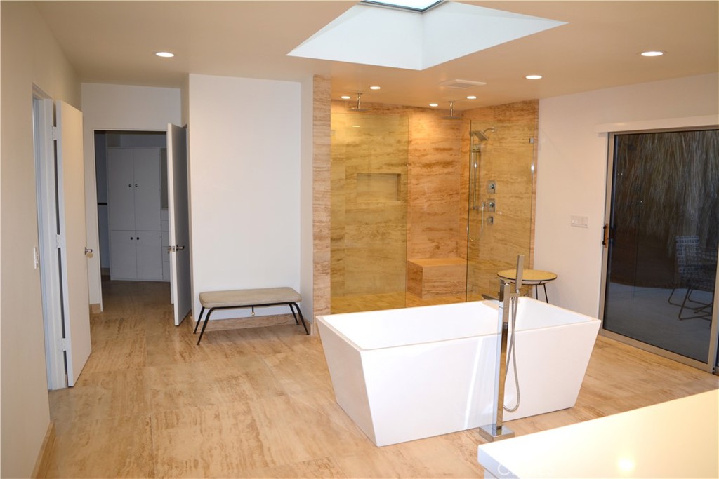 40231 Club View Drive Rancho Mirage, CA 92270 - Photo 18 of 37 a bathroom with a tub a sink and a large mirror