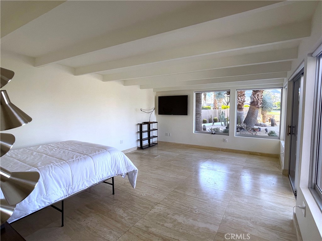 40231 Club View Drive Rancho Mirage, CA 92270 - Photo 24 of 37 a spacious bedroom with a bed and glass door