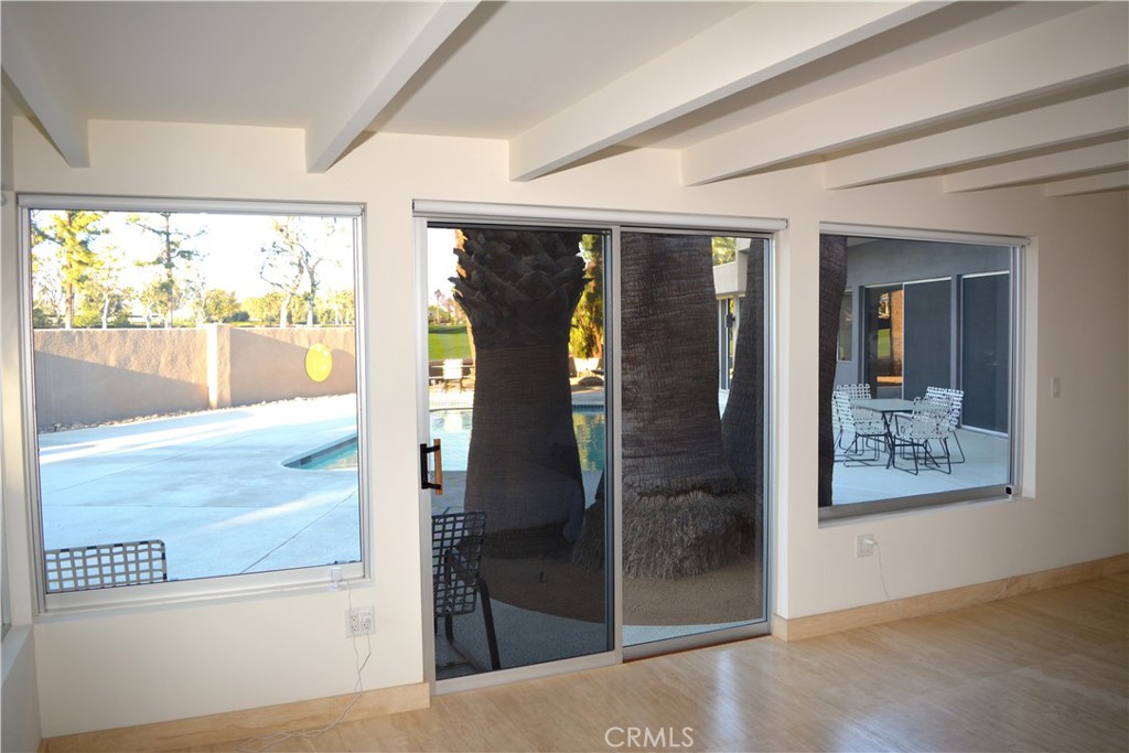 40231 Club View Drive Rancho Mirage, CA 92270 - Photo 27 of 37 a view of a hallway with wooden floor and a living room