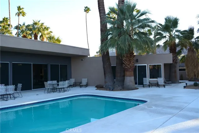 a front view of house with yard and outdoor seating