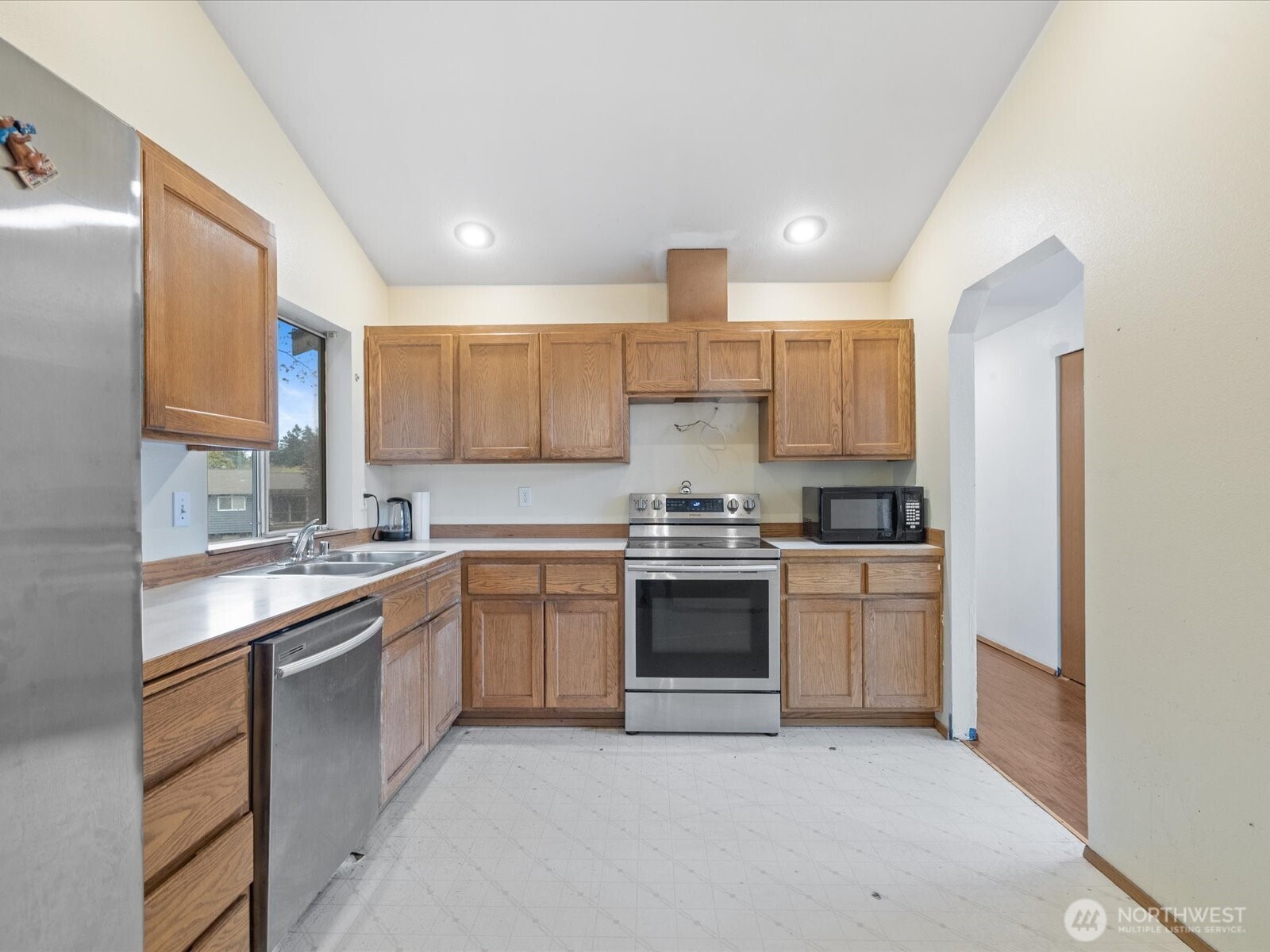 5411 158th Place Southwest Edmonds, WA 98026 - Photo 11 of 38 a kitchen with stainless steel appliances granite countertop a sink and stove top oven