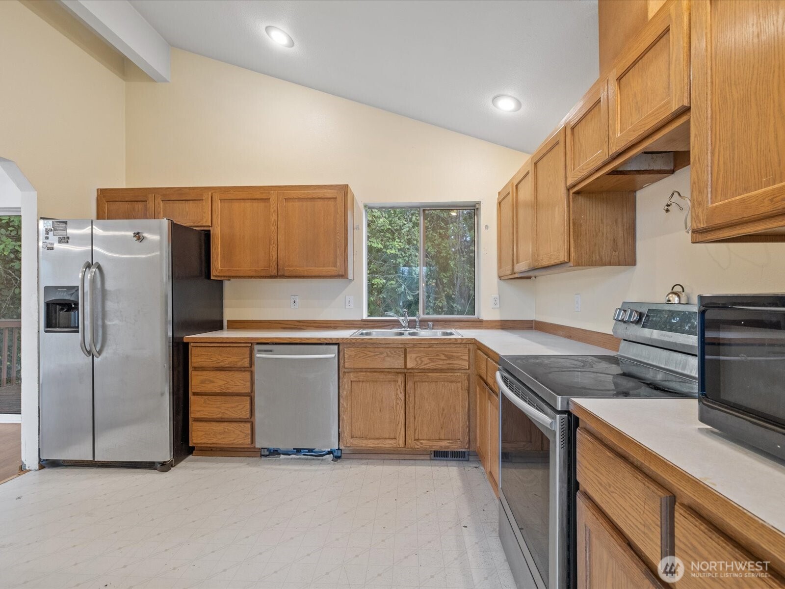 5411 158th Place Southwest Edmonds, WA 98026 - Photo 12 of 38 a kitchen with stainless steel appliances granite countertop a refrigerator sink and stove