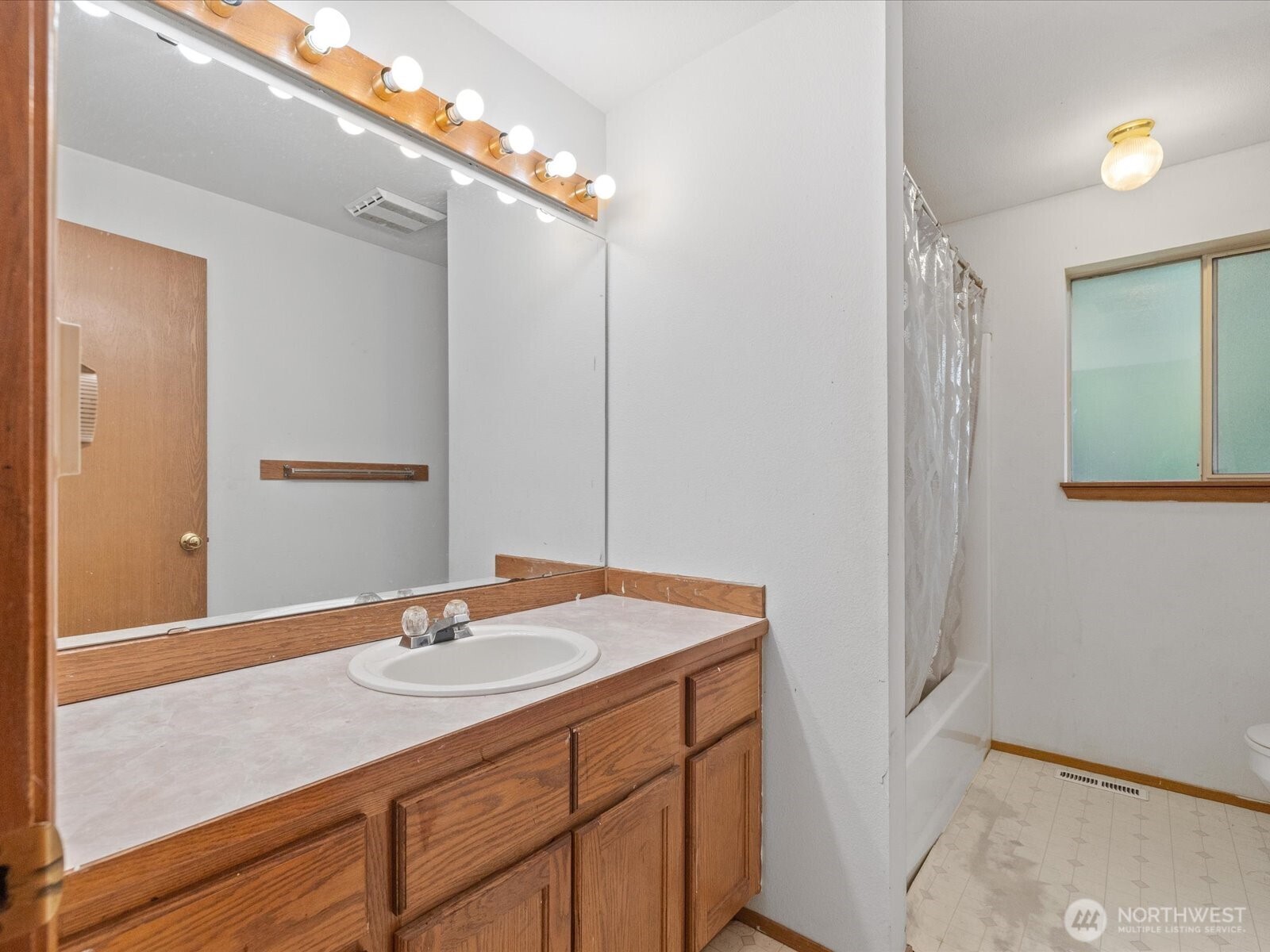 5411 158th Place Southwest Edmonds, WA 98026 - Photo 17 of 38 a bathroom with a sink vanity granite and a mirror