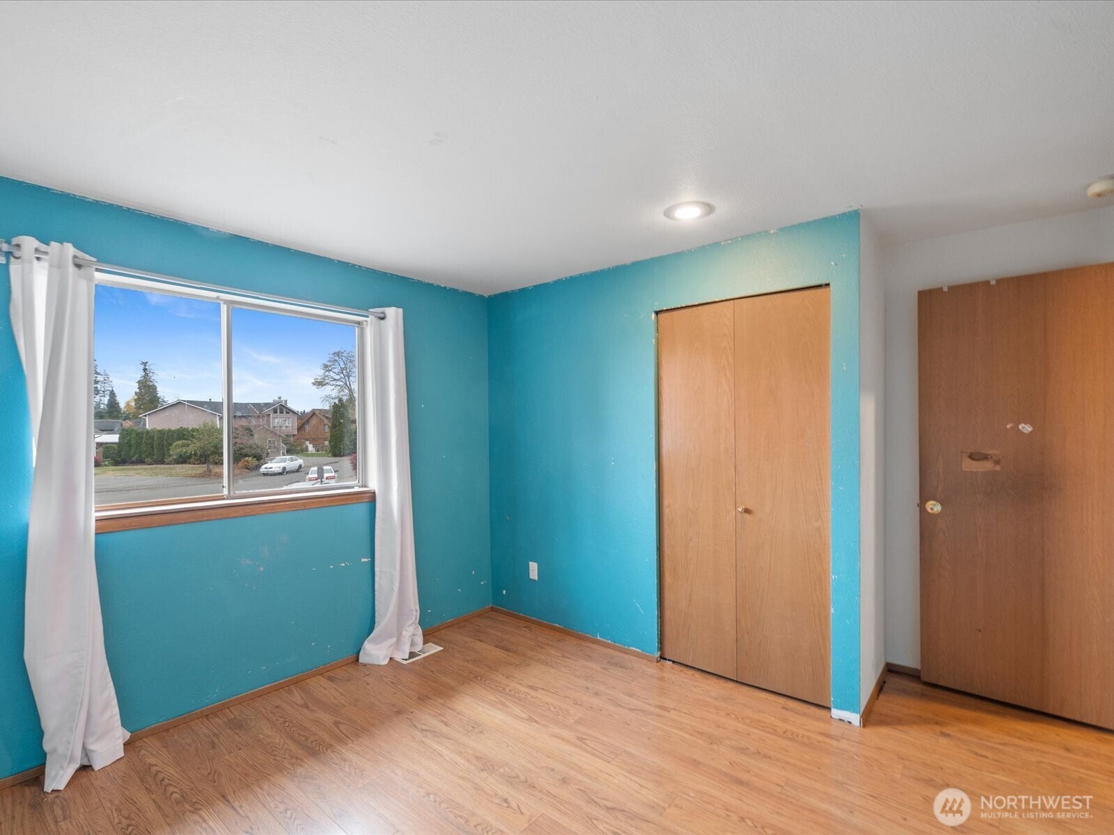 5411 158th Place Southwest Edmonds, WA 98026 - Photo 19 of 38 a view of an empty room with wooden floor and a window