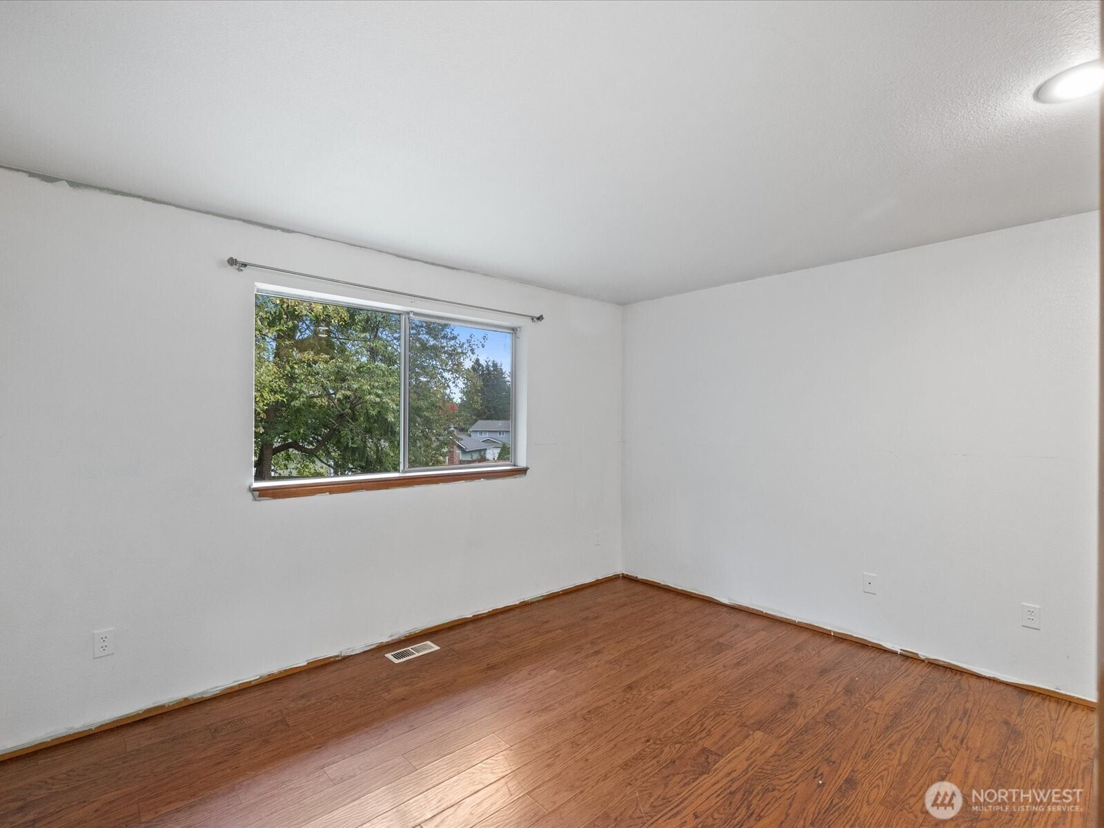 5411 158th Place Southwest Edmonds, WA 98026 - Photo 21 of 38 an empty room with wooden floor and windows