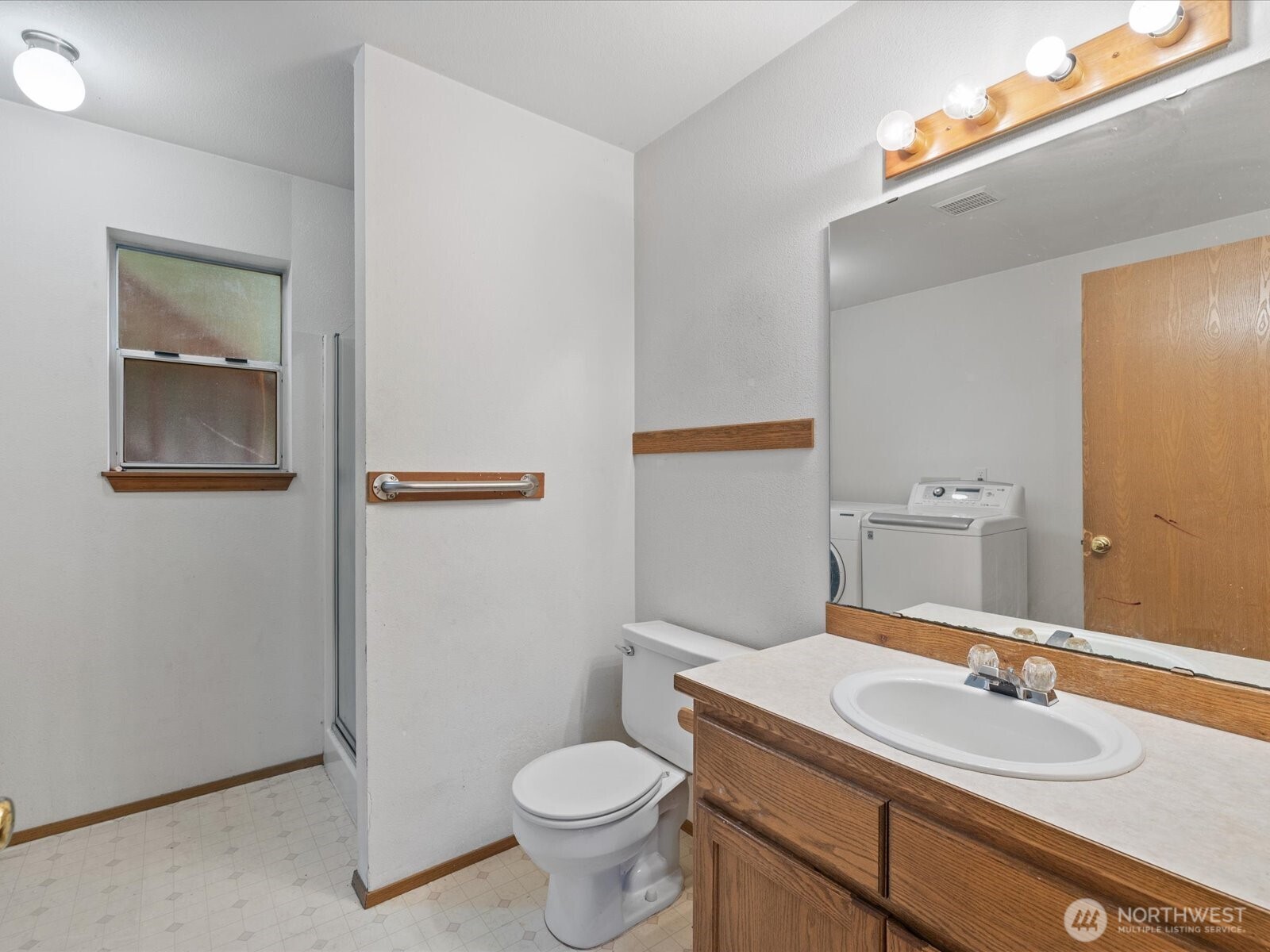 5411 158th Place Southwest Edmonds, WA 98026 - Photo 27 of 38 a bathroom with a toilet a sink and mirror
