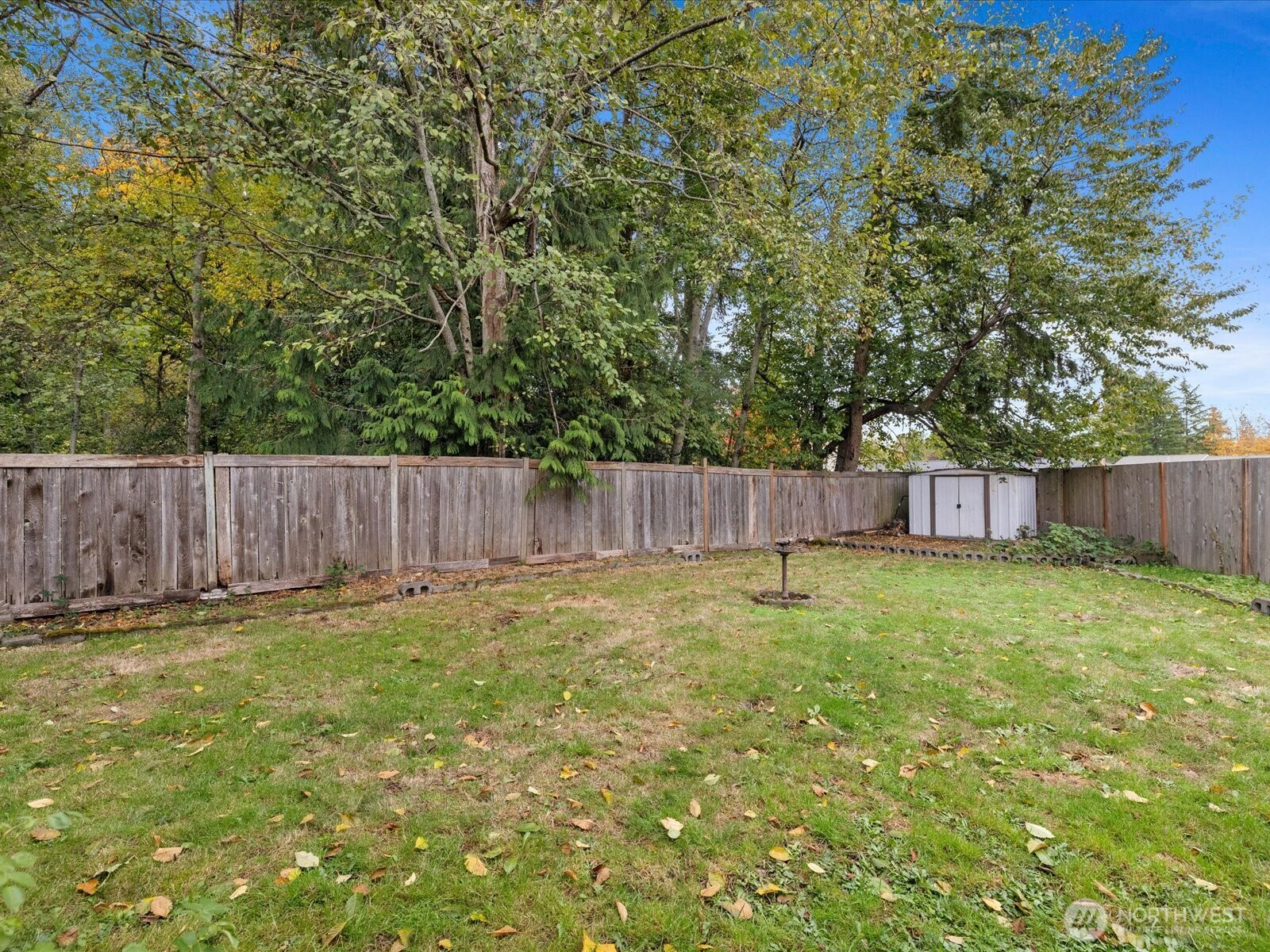 5411 158th Place Southwest Edmonds, WA 98026 - Photo 33 of 38 a backyard with wooden fence and a bench