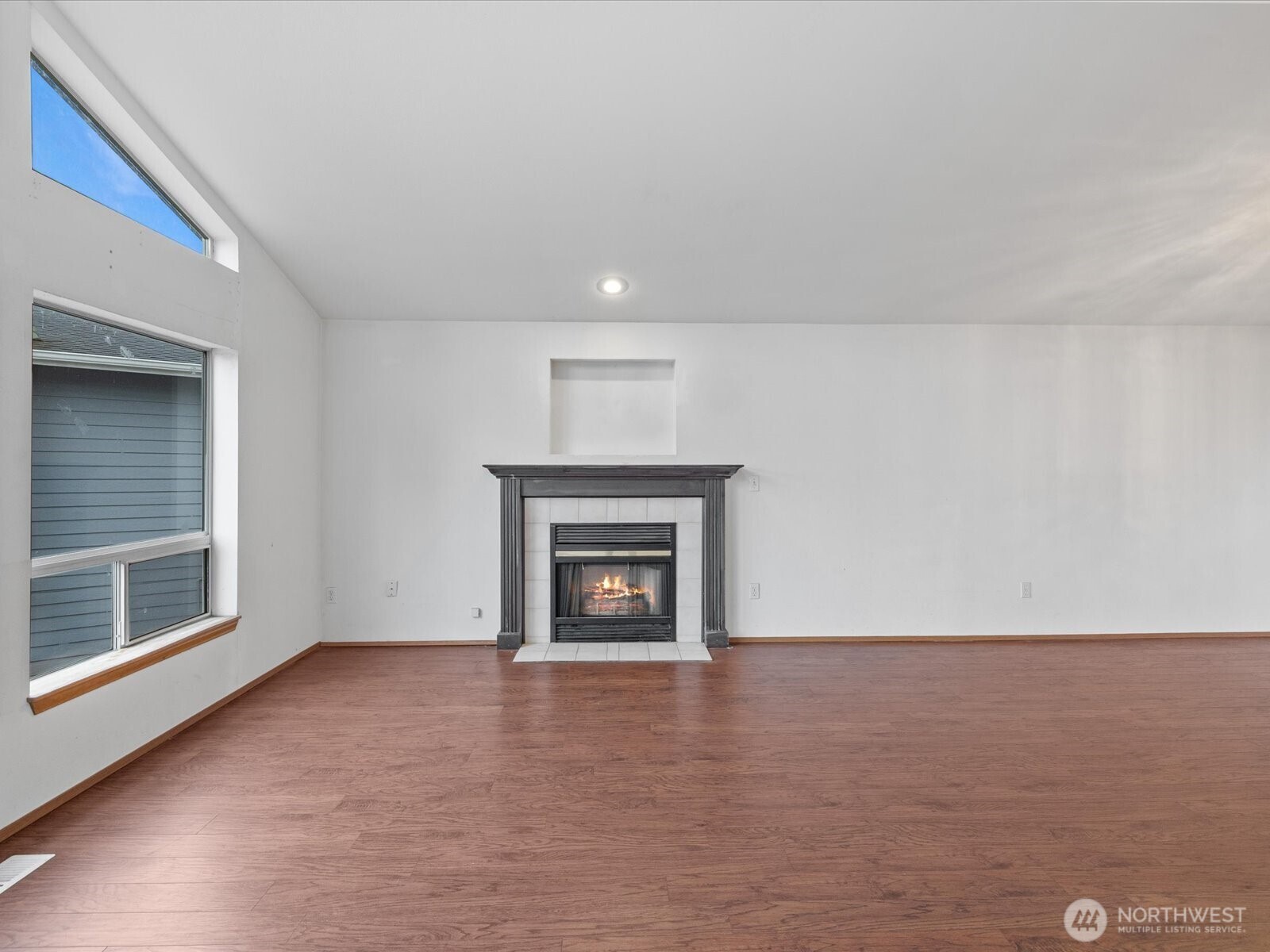 5411 158th Place Southwest Edmonds, WA 98026 - Photo 7 of 38 a view of an empty room with a fireplace and a window