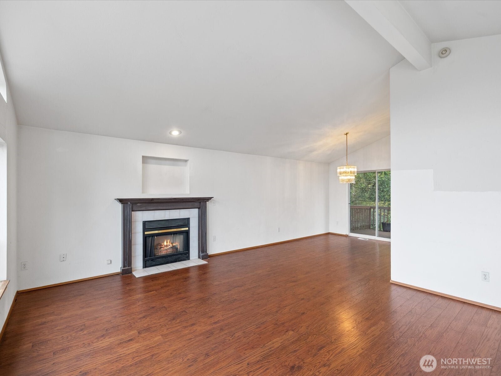 5411 158th Place Southwest Edmonds, WA 98026 - Photo 8 of 38 an empty room with wooden floor a fireplace and a window