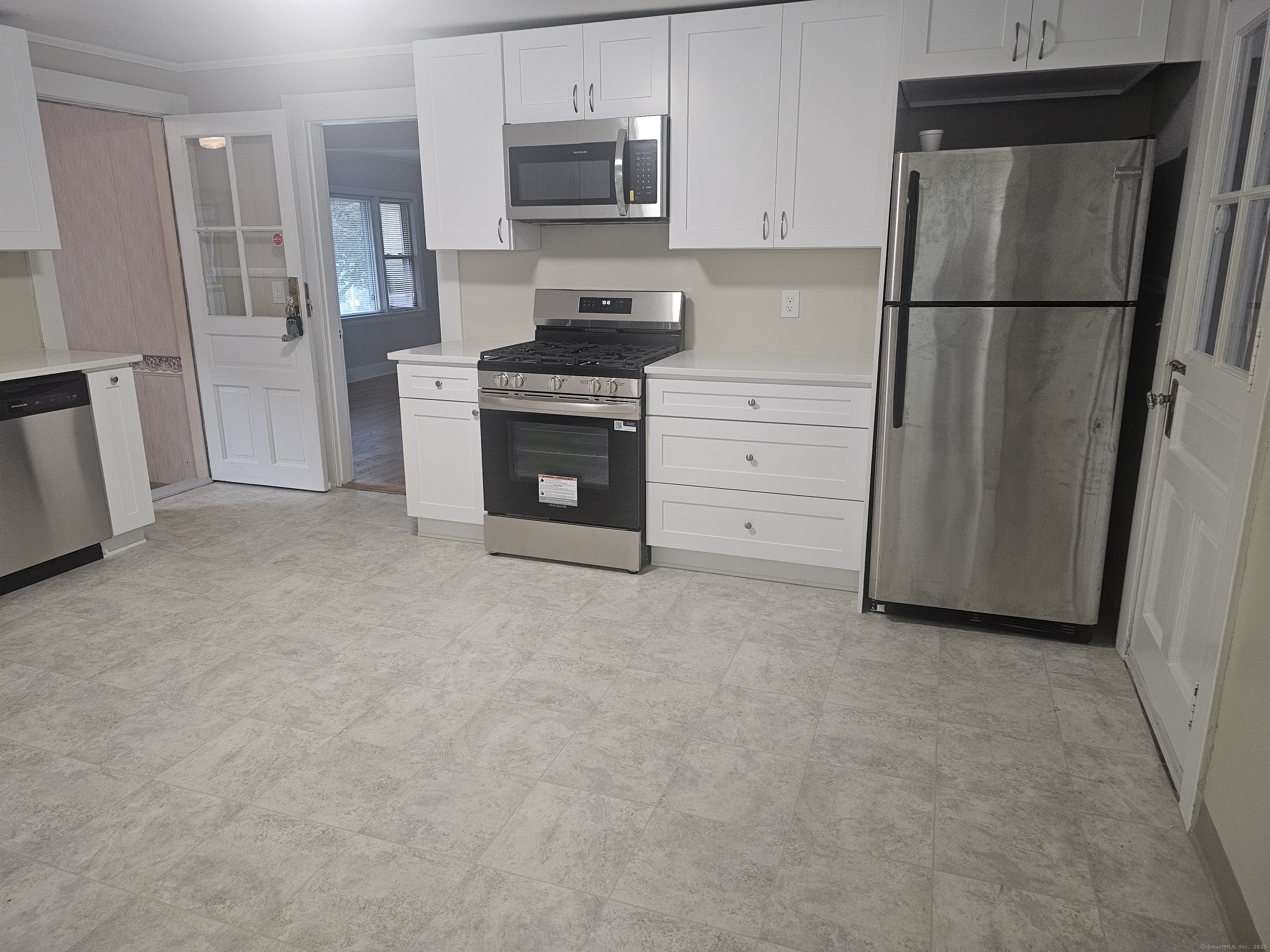8 Cliff Street Naugatuck, CT 06770 - Photo 2 of 16 a kitchen with white cabinets and stainless steel appliances