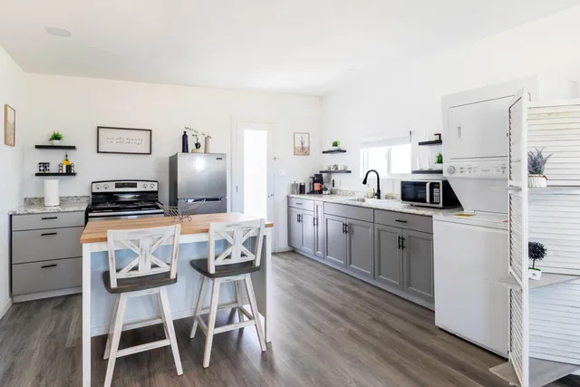 a kitchen with white cabinets and appliances