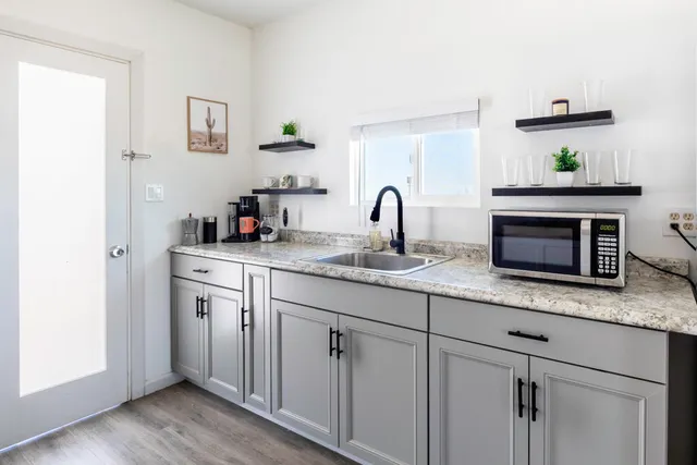 a kitchen with sink cabinets and wooden floor