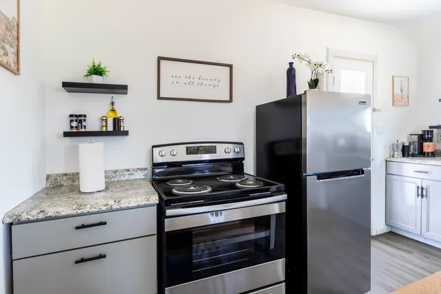 a kitchen with refrigerator and stove
