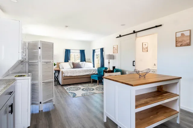 a bedroom with furniture and a large window