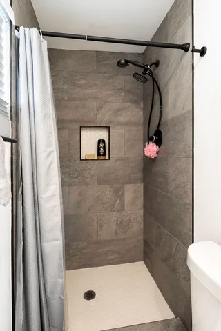 a bathroom with a shower and toilet