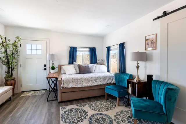 a bedroom with furniture and wooden floor