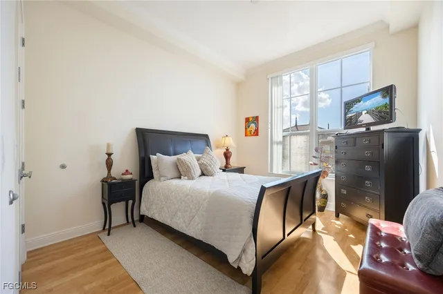 a bedroom with a bed and wooden floor