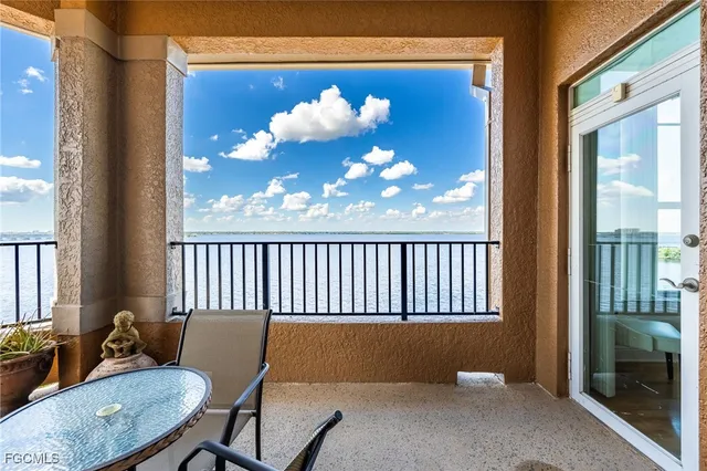 a view of a room with a large window and furniture