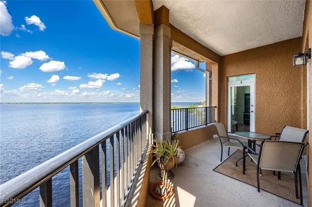 a view of a balcony with furniture and chandelier