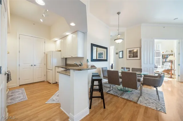 a living room with kitchen island furniture and a wooden floor