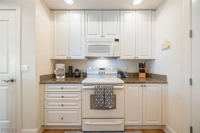 a kitchen with stainless steel appliances granite countertop a sink and cabinets