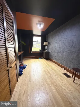 a view of a room with wooden floor