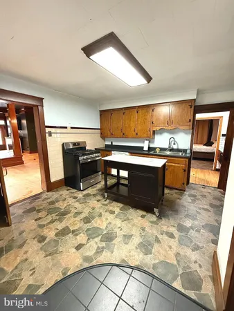 a kitchen with stainless steel appliances granite countertop a sink stove and cabinets