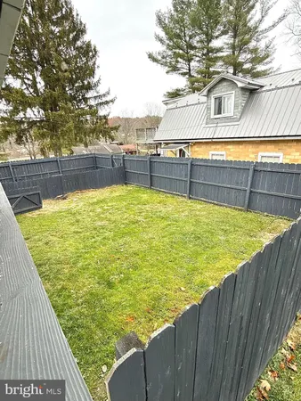 a view of a kitchen with a stove and cabinets