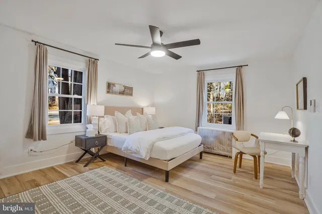 a bedroom with a bed and windows