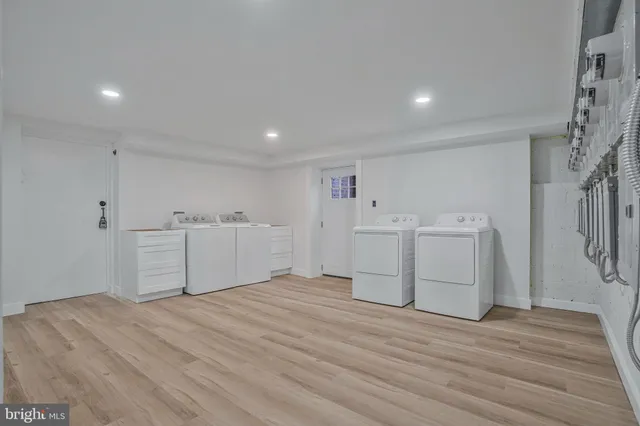 a view of a room with cabinets and wooden floor